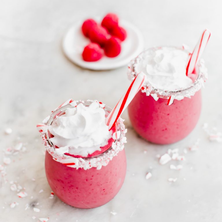 Add all the ingredients into a blender and blend till smooth and creamy. Pour into a glass and top with coconut whipped cream and candy cane. Enjoy!