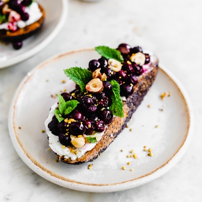 Oven Roasted Blueberries and Honeyed-Hazelnut Clusters Over Goat Cheese Toast