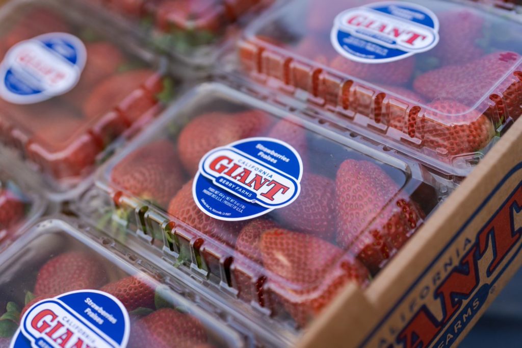 clamshells of strawberries on display